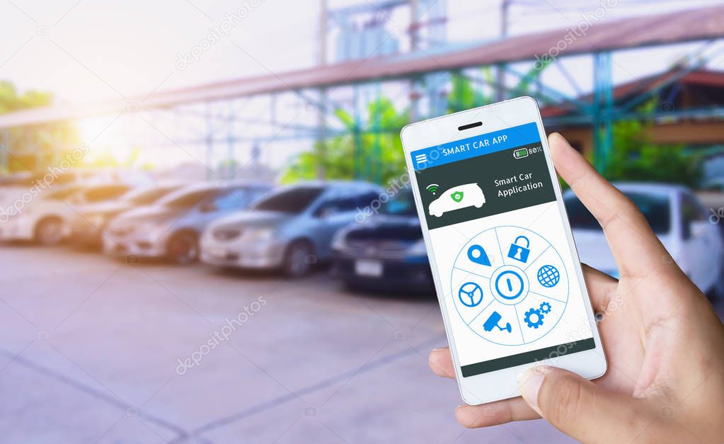 Auto parking and Smart pick me up application, Auto drive function and internet of things in smart car concept. Hand holding smart phone and application dashboard with blur car parking background.