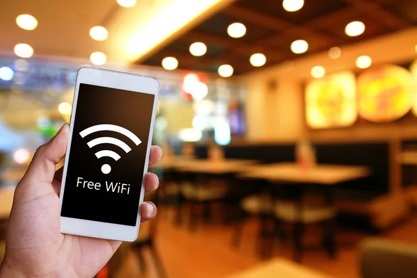 Adam beyaz bir genel smartphone ücretsiz Wi-Fi gösterilen tutuyor. Kamu erişim noktasına bağlanma.