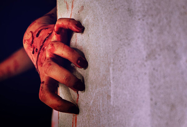 Horror scene with a dirty hand with blood. Zombie hand concept. Halloween concept.