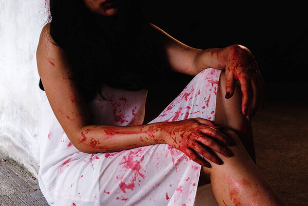Horror Scene with woman cover the red blood on the body. Halloween concept.