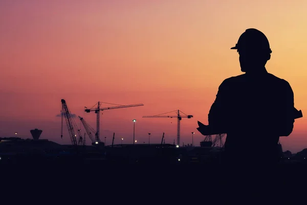 Industry icon pattern on silhouette construction site landscape.