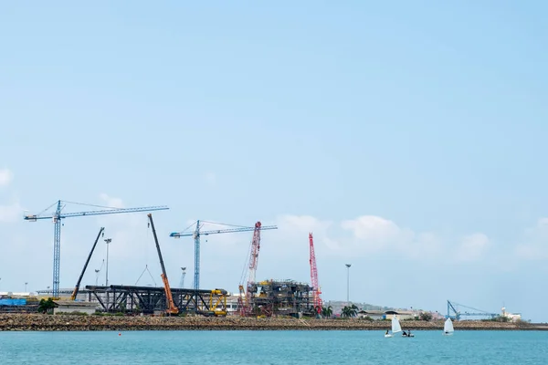 Construction site and blue sea. — Stock Photo, Image