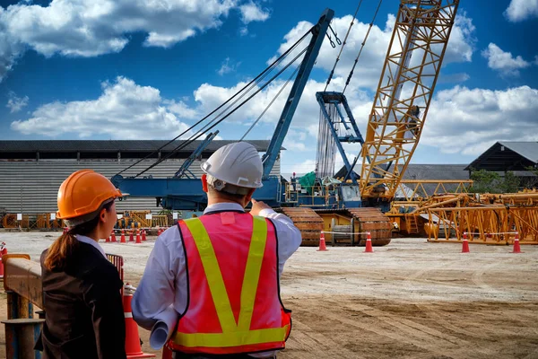 Mobile Crane and Mobile Heavy Crane in construction site. Engineers are doing inspection crane. Manager worker explain task in site project.