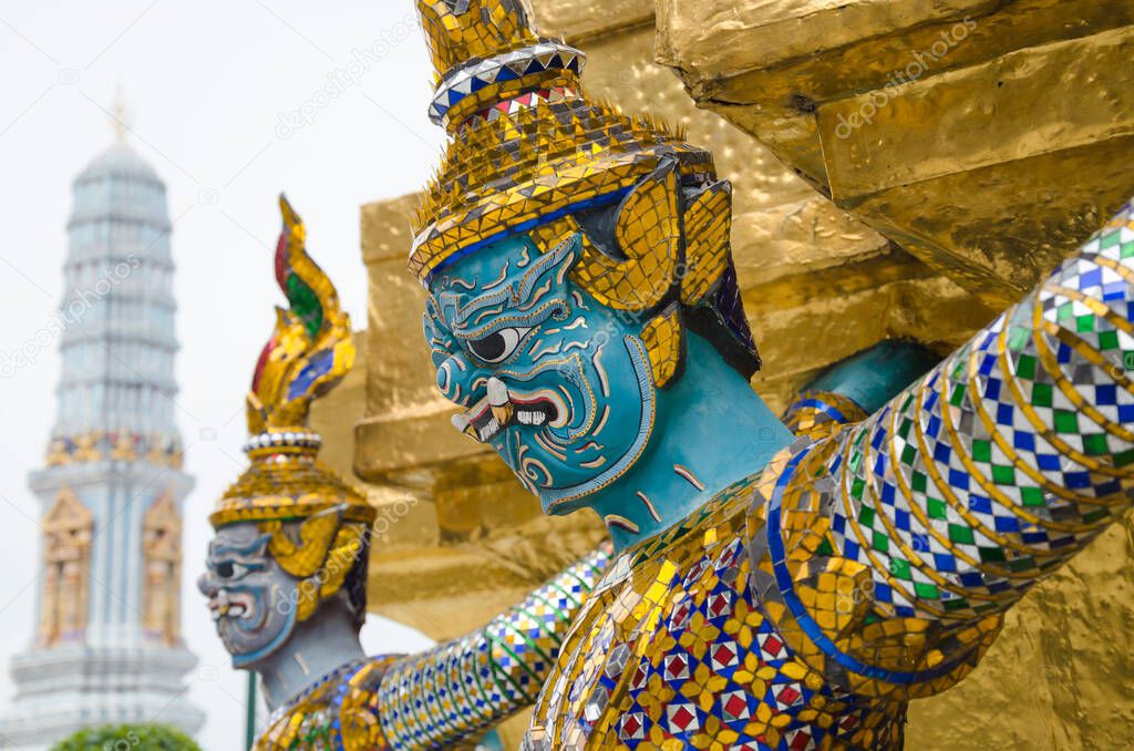 Giant Statue Surround the Basement of Grand Gold Stupa is One of Landmark of Wat Phra Kaew Monastery, Bangkok of Thailand.