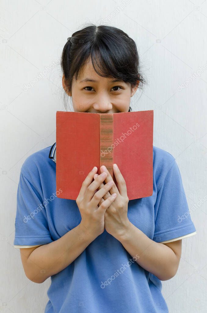 Asian Teenager Girl Happy after Reading a Book.