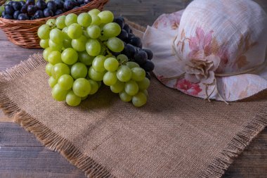 Sabah köyde kahvaltıda toplanan olgun, sulu yeşil ve siyah üzüm kümeleri.