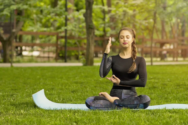 Young Caucasian woman meditating in Lotus position. Yoga in the — Stock Photo, Image