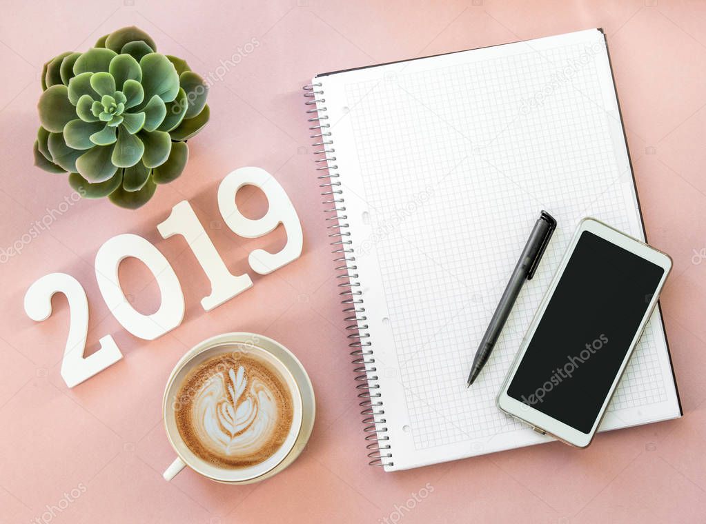 Happy New Years layout. numbers 2019 notepad and free space for text. Christmas decorations, Christmas toys, gold stars. Goals for the new year. mock up mobile phone