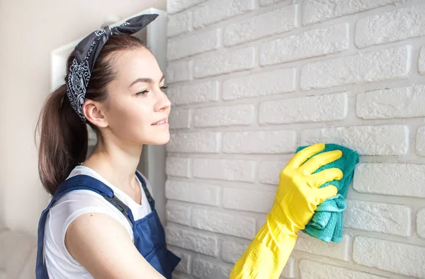 Cleaning service with professional equipment during work. professional kitchenette washing, sofa dry cleaning, window and floor washing. women in uniform, overalls and rubber gloves.