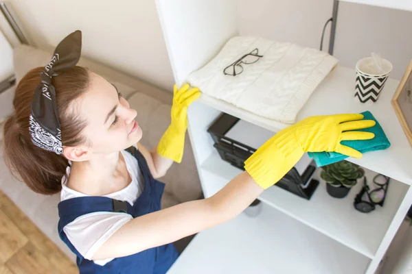 Cleaning service with professional equipment during work. professional kitchenette washing, sofa dry cleaning, window and floor washing. women in uniform, overalls and rubber gloves.