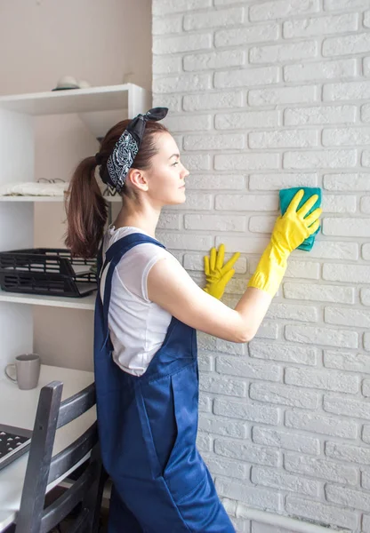 Cleaning service with professional equipment during work. professional kitchenette washing, sofa dry cleaning, window and floor washing. women in uniform, overalls and rubber gloves.