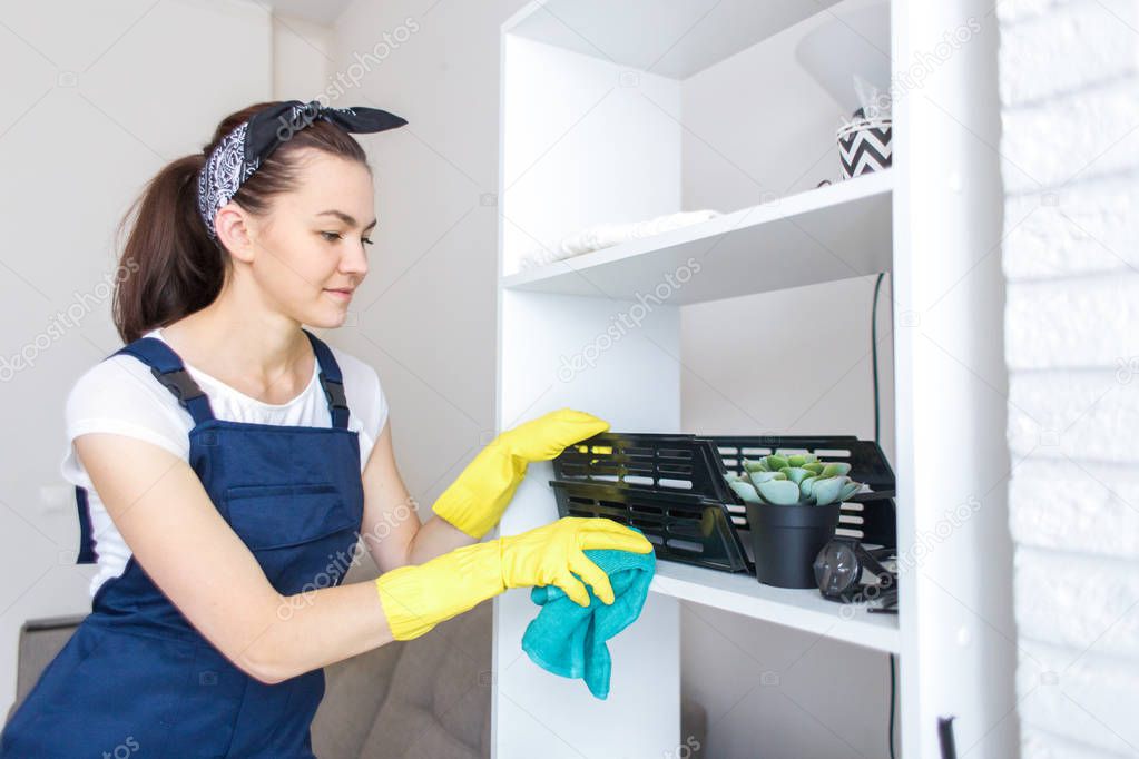 Cleaning service with professional equipment during work. professional kitchenette washing, sofa dry cleaning, window and floor washing. women in uniform, overalls and rubber gloves.