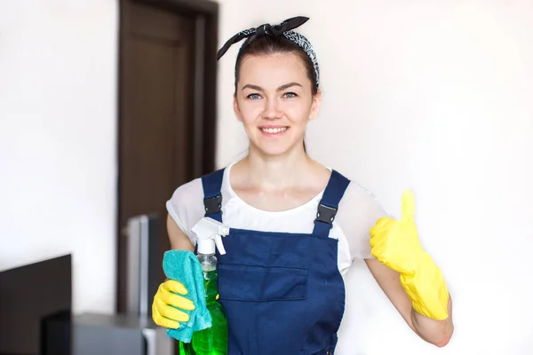 Cleaning service with professional equipment during work. professional washing, sofa dry cleaning, window and floor washing. woman in uniform, overalls and rubber gloves. Isolated, space for text