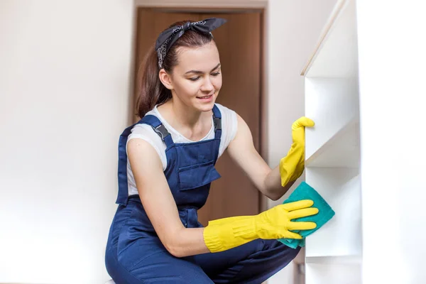 Cleaning service with professional equipment during work. professional kitchenette washing, sofa dry cleaning, window and floor washing. women in uniform, overalls and rubber gloves.