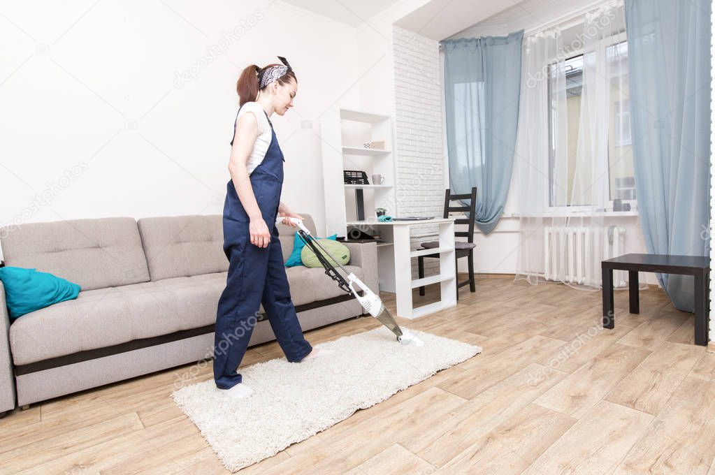 Cleaning service with professional equipment during work. professiona carpet dry cleaning, sofa dry cleaning, window and floor washing. women in uniform, overalls and rubber gloves.