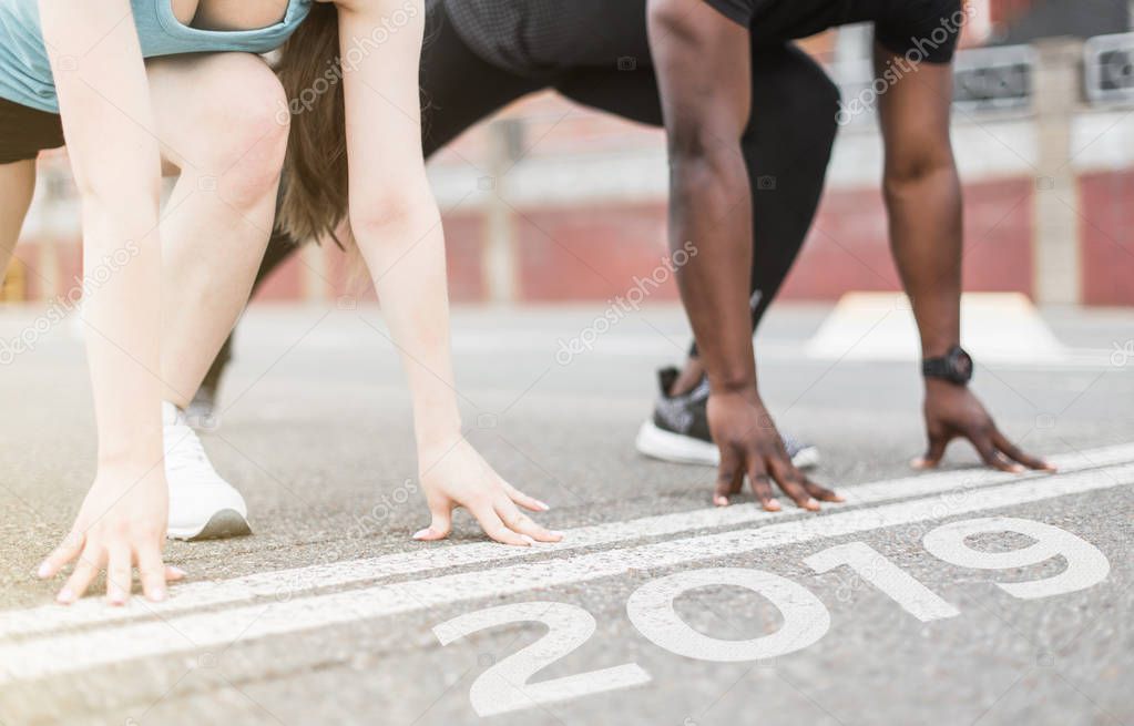 young couple afro-american man and european woman run together. A loving couple is run, engaged in sports, family values. finish 2018. Start to new year 2019, plans, goals, objectives