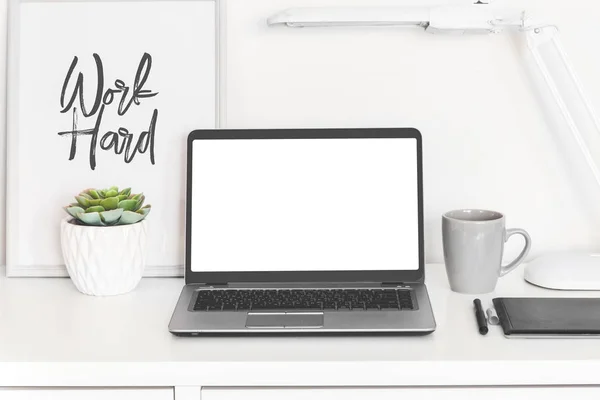 laptop computer white blank screen on work table front view, office desk with succulent flower