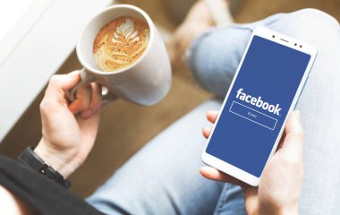 Ufa, Rusya 20 Ocak 2019: WOMANS ellerinin mockup görüntü barda uyluk ve kahve bardağı boş ekran ile beyaz cep telefonu tutarak.