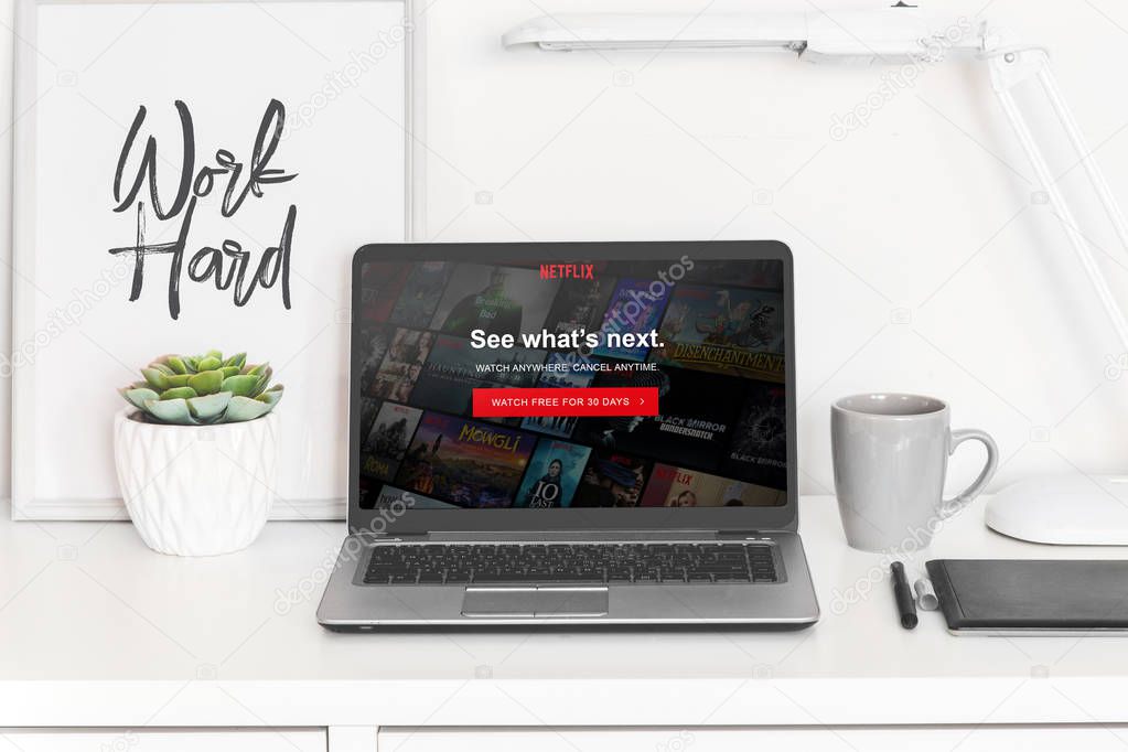 Ufa, Russia January 20, 2019: laptop computer white blank screen on work table front view, office desk with succulent flower.