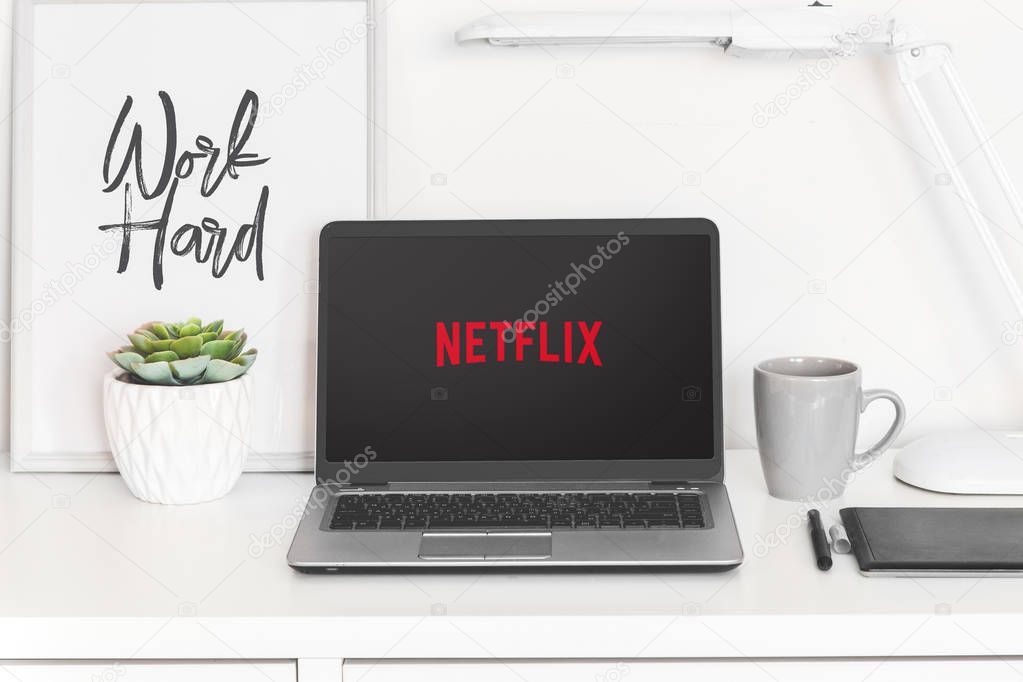 Ufa, Russia January 20, 2019: laptop computer white blank screen on work table front view, office desk with succulent flower.