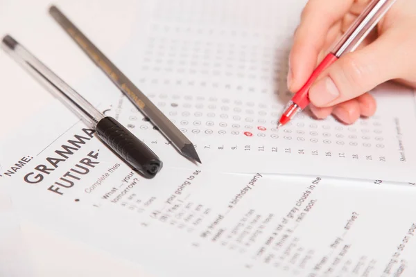 Test of English multiple choice on table.Woman takes an entrance exam — Stock Photo, Image