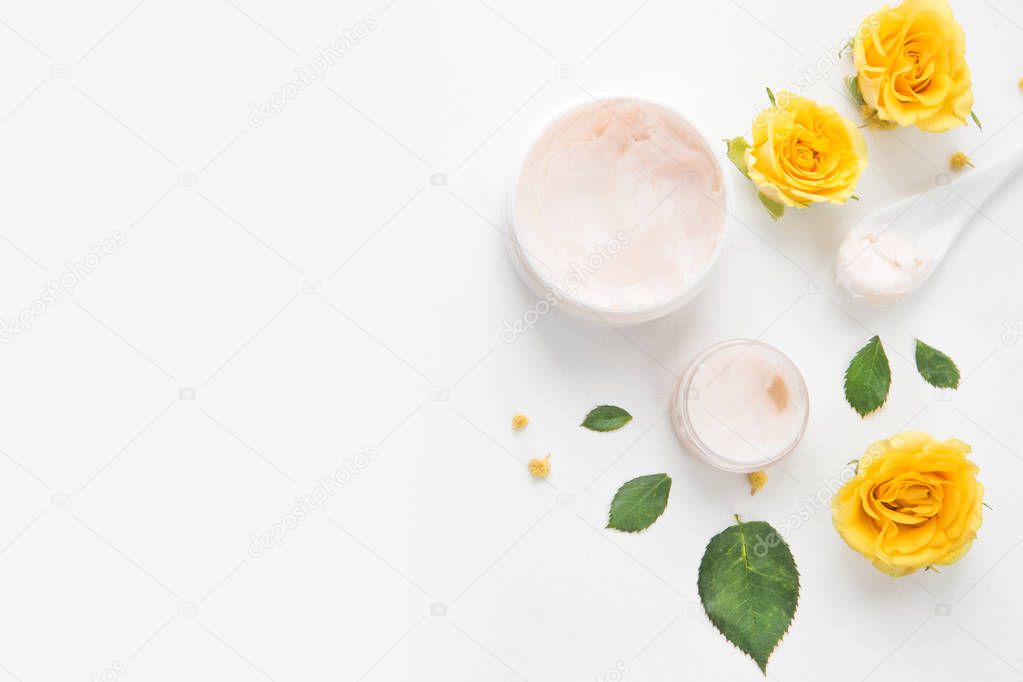 Composition with yellow roses and hand cream. morning face and body care. spa and massage