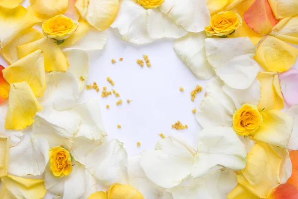 Minimal style. Minimalist Fashion photography. yellow rose petals set on white background. Flatlay. Top View