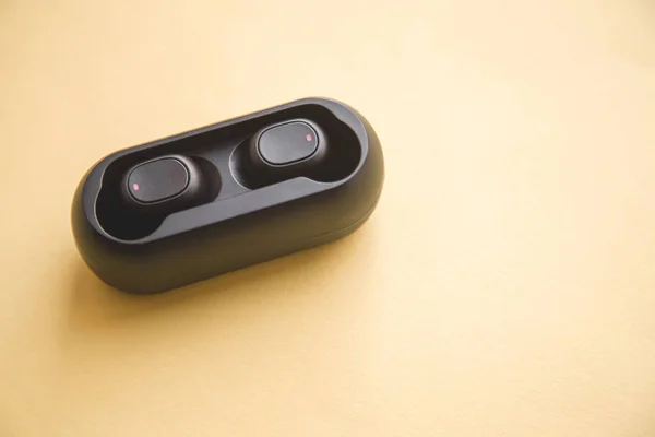 Μαύρο ασύρματα ακουστικά με μικρόφωνο σε κίτρινο φόντο — Φωτογραφία Αρχείου