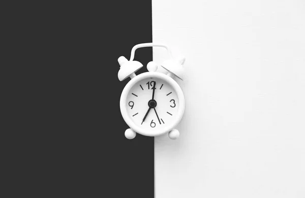 White table clock, alarm on black white background, top view. Good morning. Minimalism — Stock Photo, Image