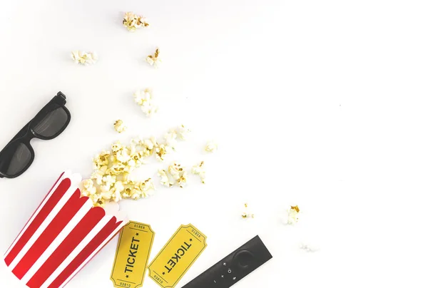 Cinema party concept. movie tickets, clapperboard, pop corn and 3d glasses in a white background. Flat lay