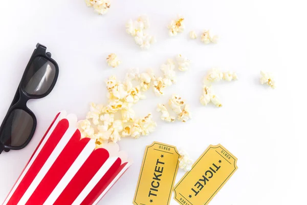 Cinema party concept. movie tickets, clapperboard, pop corn and 3d glasses in a white background. Flat lay