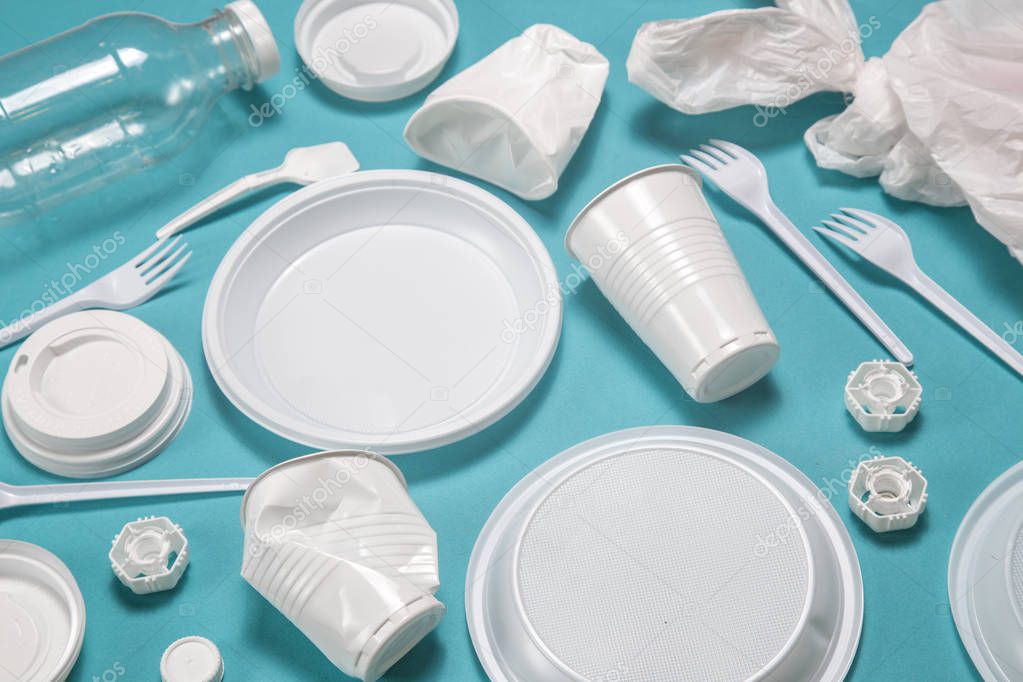 Flat lay composition disposable plastic tableware. plastic processing problem