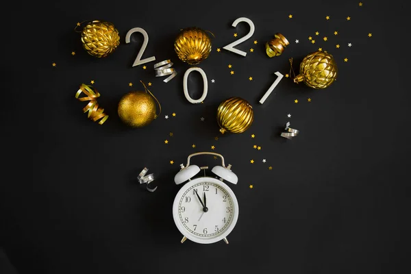 New Year Christmas Top view flat lay white alarm clock twelve covered golden stars confetti copy space black color paper background minimal style — Stock Photo, Image