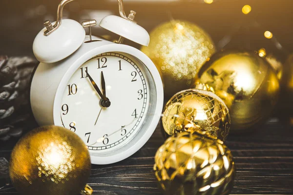 change from 2020 to 2021 on the clock. New Years Eve and Christmas. Alarm clock and Christmas golden balls.