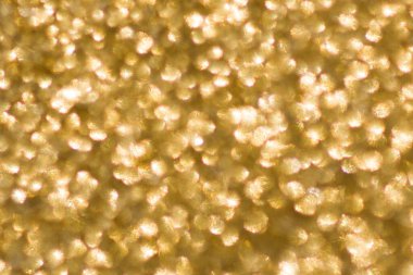 Kopya alanı olan soyut altın arkaplan. Parıltı ve bokeh. Noel ve yeni yıl konsepti.