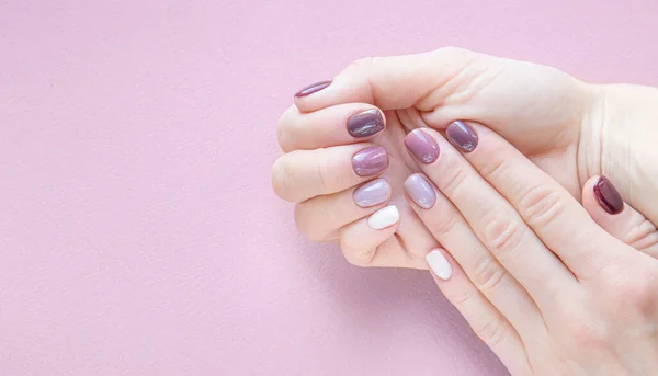 hardware manicure done in a beauty salon. purple color gradient on nails