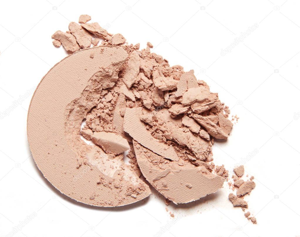 scattered beige nude powder isolated on white background