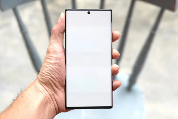 Adamın eli yeni bir akıllı telefon tutuyor..