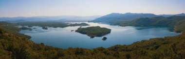 Birçok küçük adalar ile dağlarda Gölü nün panoramik görünümü. Karadağ, Salt Lake yakınındaki şehir Nikšić