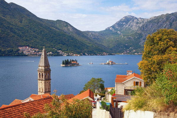 Beautiful autumn Mediterranean landscape. Montenegro, Adriatic Sea. View of  Bay of Kotor with two small islands and  bell tower of the church of St. Nicholas in Perast town