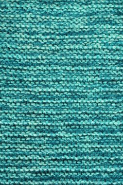Örgü örüyorum. Mavi-yeşil arka plan, ev yapımı doku. Hobi konsepti
