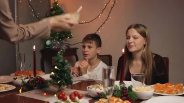 Genç bir aile Noel yemeği yiyor.