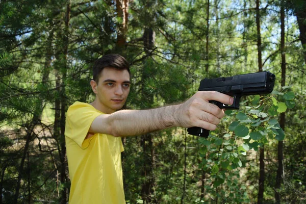 Young Man Yellow Shirt Shoots Pistol Forest — Stock Photo, Image