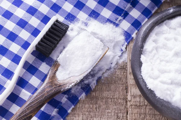 Baking soda and brush are the wood table — Stok Foto