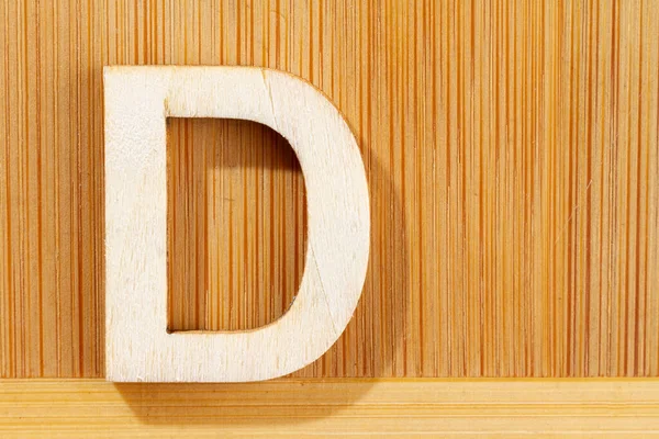 Letter D of wood-made alphabet, top view and space for text — Stock Photo, Image