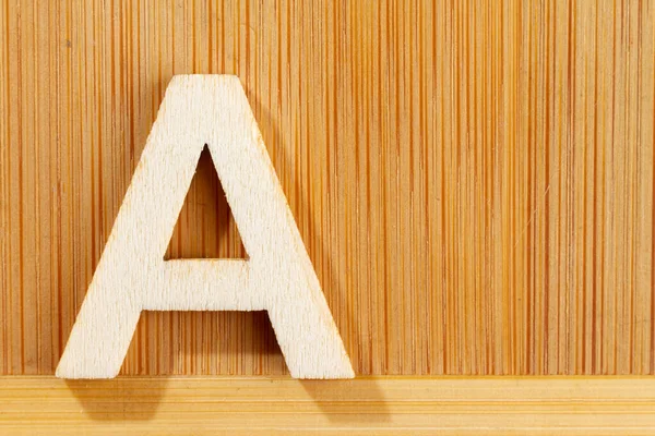 Letter A of wood-made alphabet, top view and space for text — Stock Photo, Image