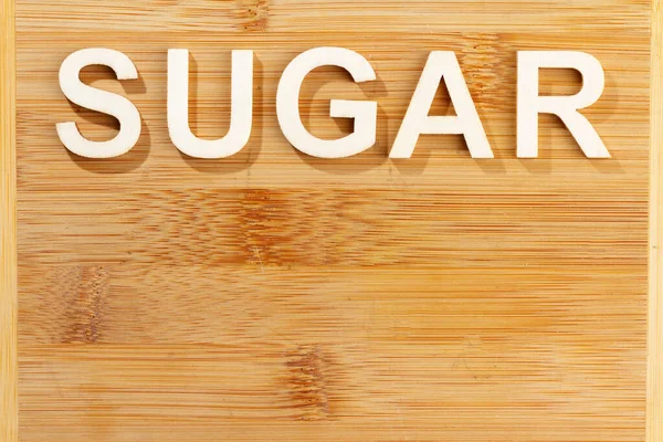 Слово сахар, написанное деревянными буквами, место для текста — стоковое фото