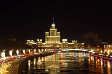 Night view of the Moskvoretskaya and Raushskaya embankments. High-rise building on Kotelnicheskaya embankment, Moscow, Russia clipart
