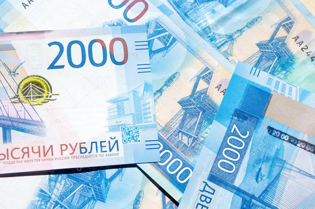 New russian banknotes of 2000 rubles close-up, background