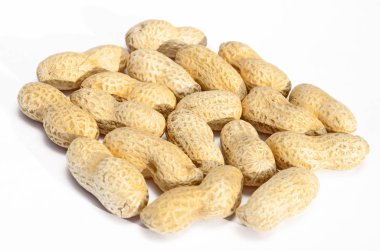 Beyaz arka planda soyulmamış fıstıklar.